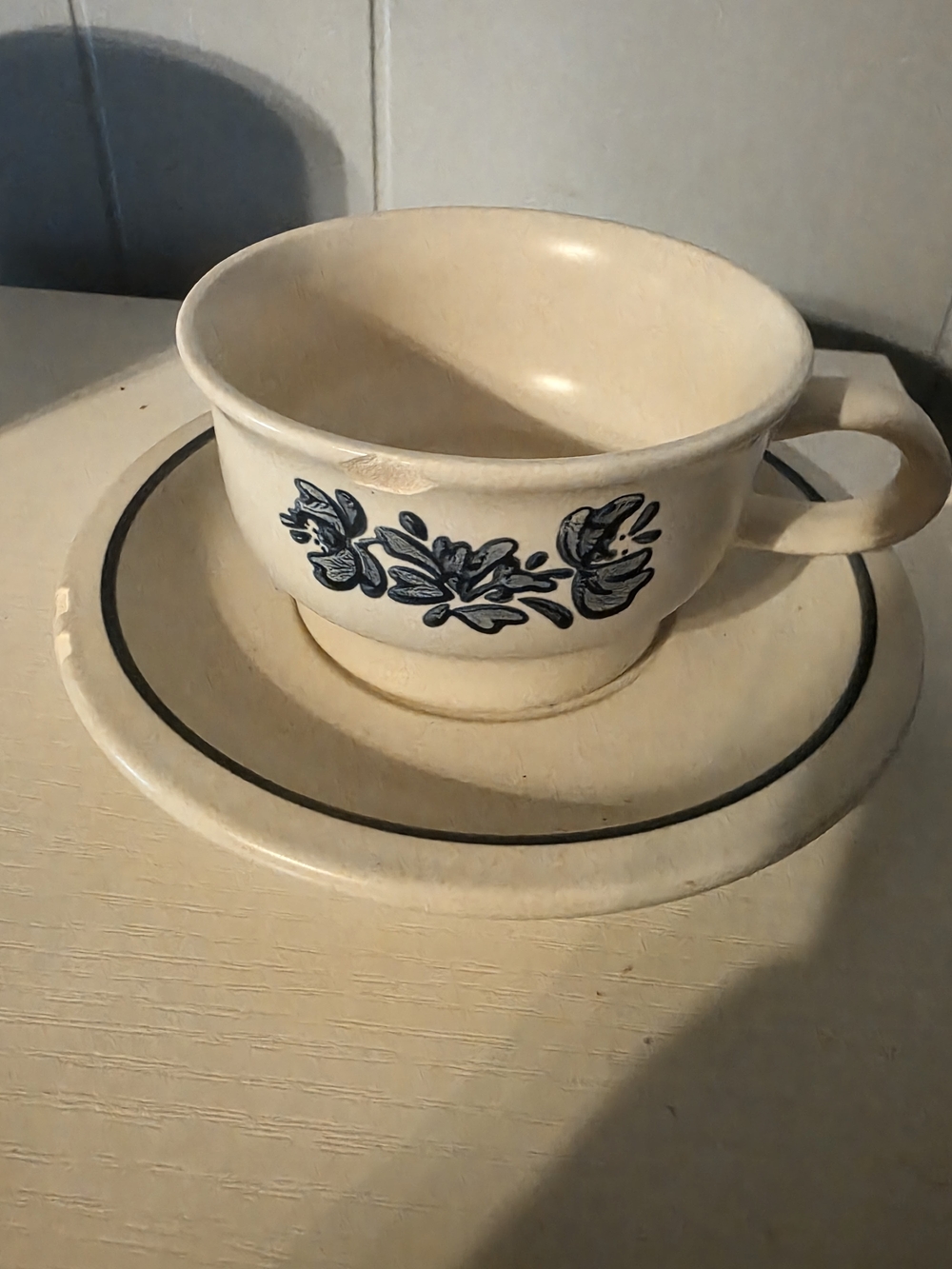Vintage Cream Stoneware Teacup & Saucer with Blue Floral Design